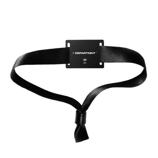 A woven wristband in black, with a flat plate at the front of it