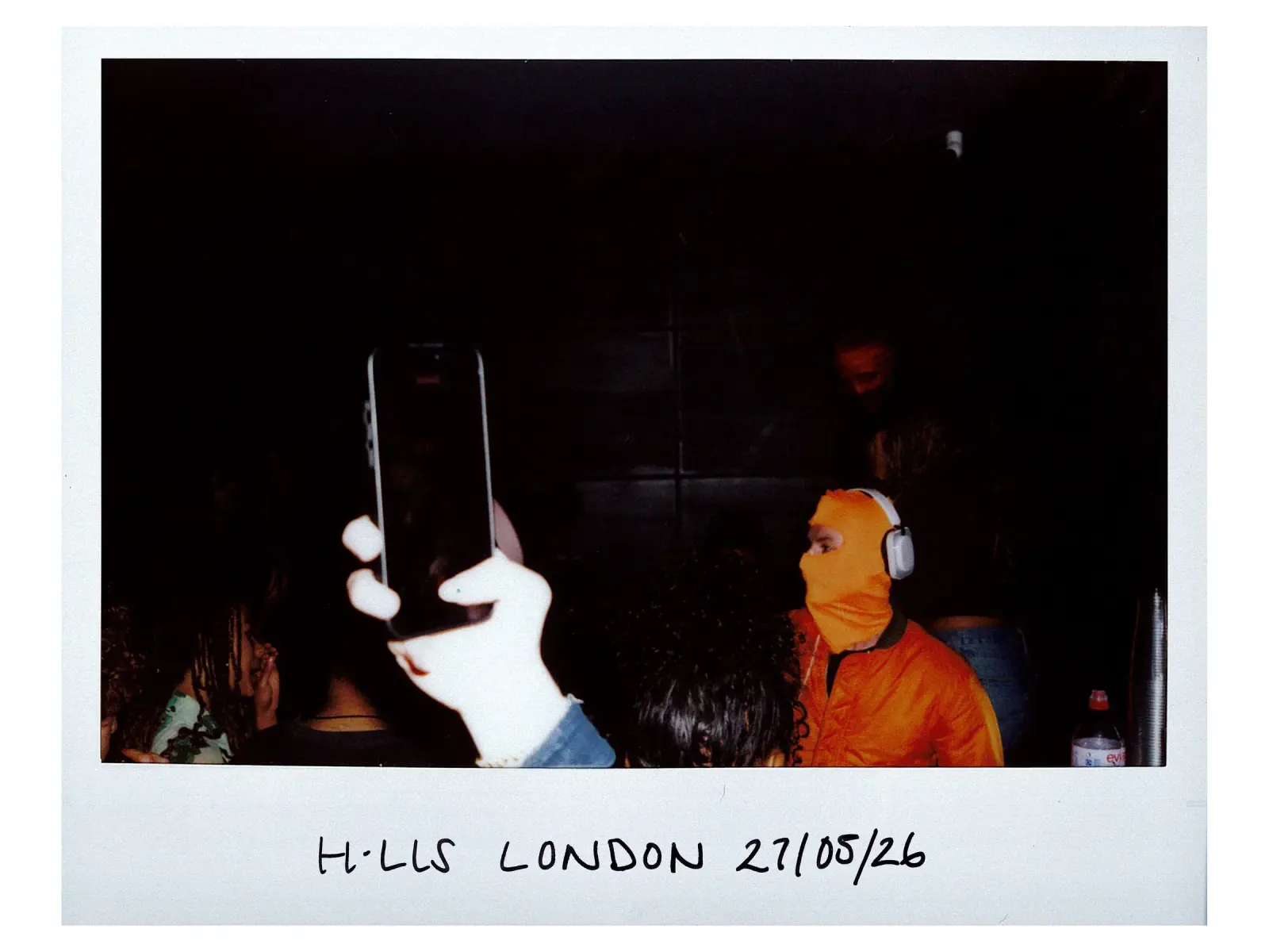 London listening event I: a phone up beside a masked member