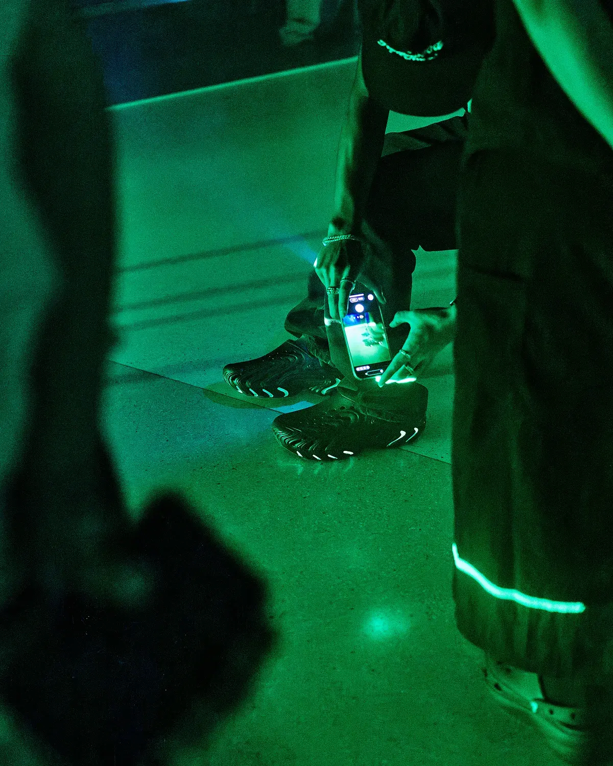 Someone photographing the shoe on the floor