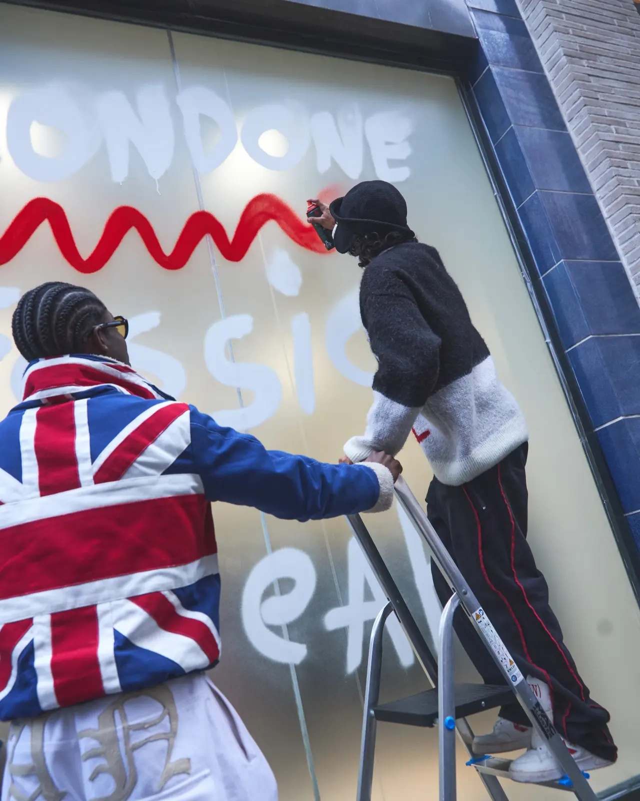 Painting the Londone Fassion Weak window at END. Soho