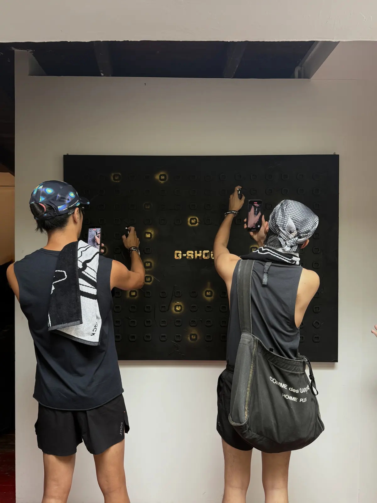 Two runners, phones to the wall