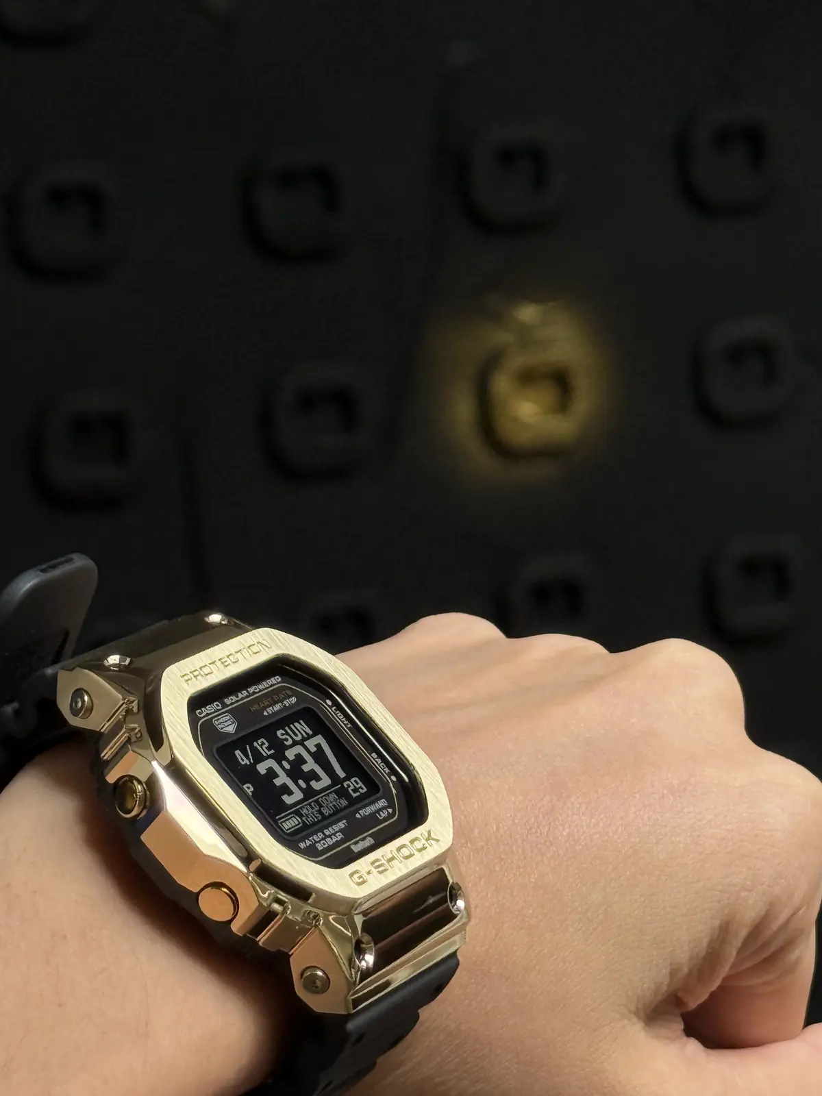 A G-SHOCK by a lit cell
